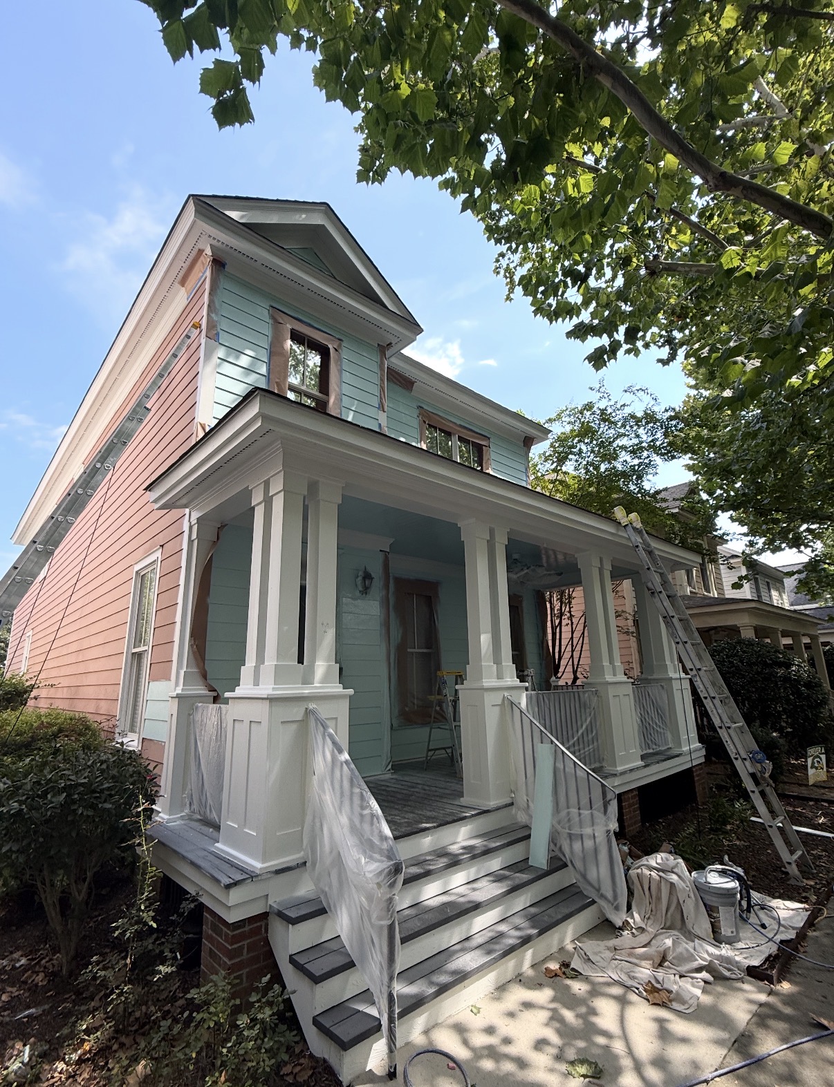 Two-story historic home on scaffolding being repainted from salmon pink to a lighter color — Two-Story Historic Exterior Repaint in Columbia, SC