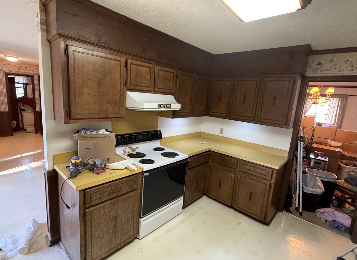Before photo of a dated kitchen with dark oak cabinets and yellow laminate countertops — Kitchen Cabinet Refinish in Deep Blue in Lexington, SC