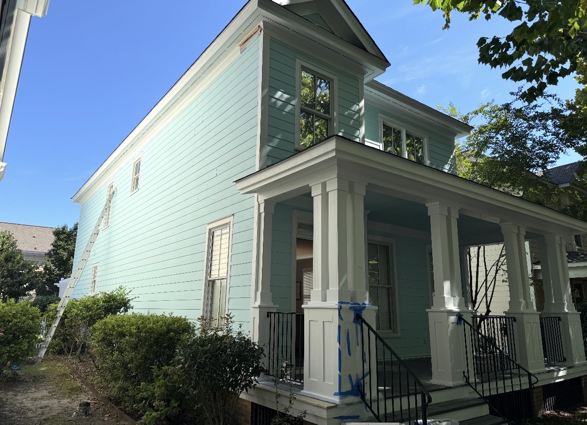 Completed two-story exterior repaint in soft sage green with white trim — Two-Story Historic Exterior Repaint in Columbia, SC